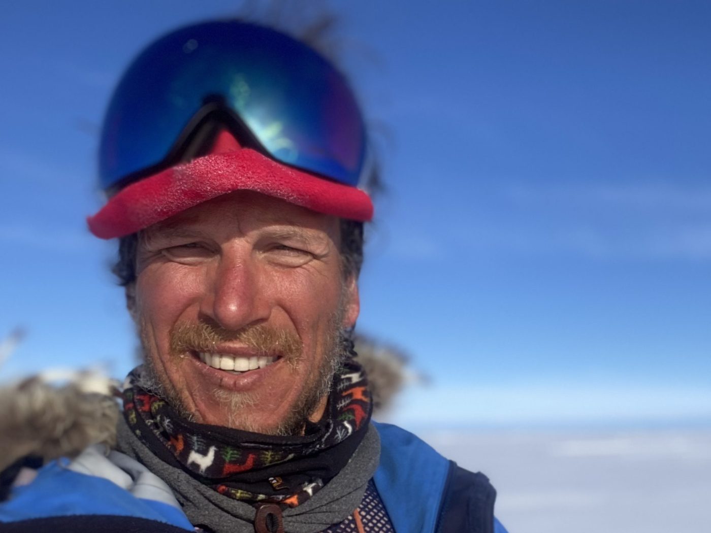 Ben Weber in ski goggles and a fur-ruffed jacket on the Antarctic plateau