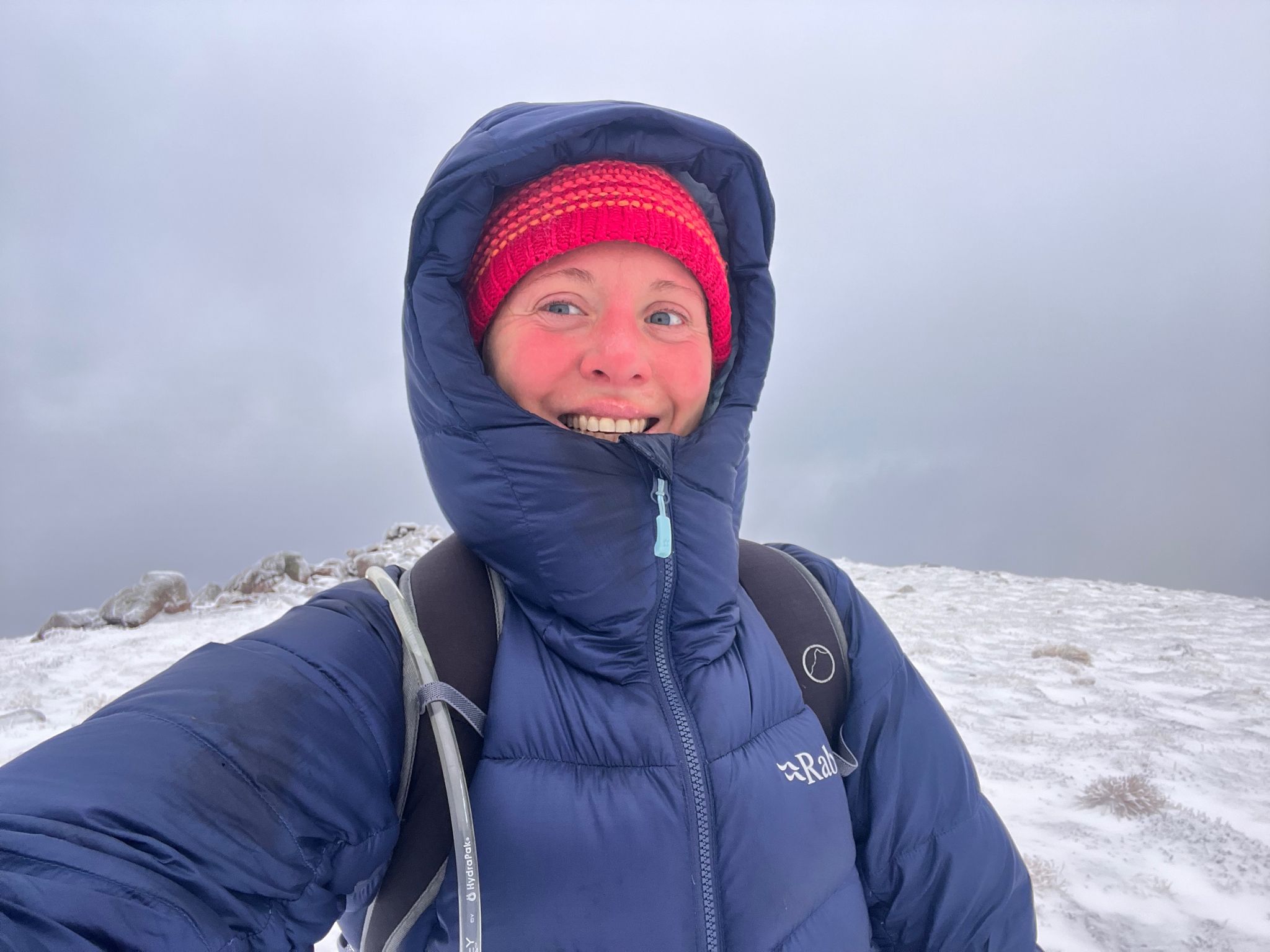 Erica Stanford on the summit of Ben Nevis in Scotland with cloud behind