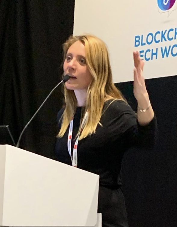 Erica Stanford speaking at a blockchain and technology conference